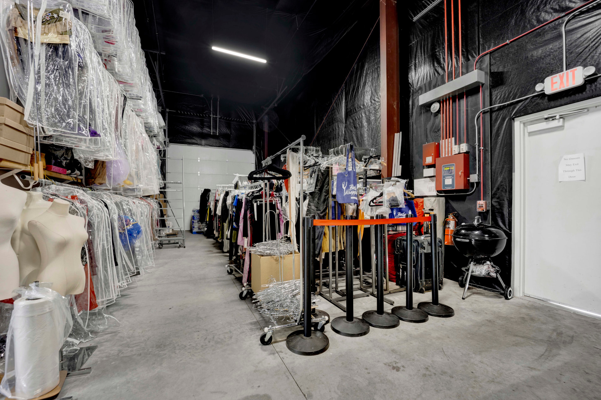 Christy's costume closet at Virtues In Motion, filled with racks of dance costumes